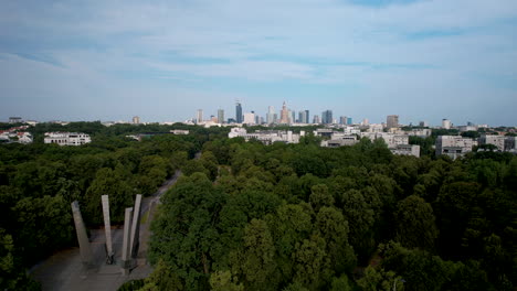 Aerial-view-over-Chwala-Saperom-memorial-park,-panoramic-Warsaw-skyline-view