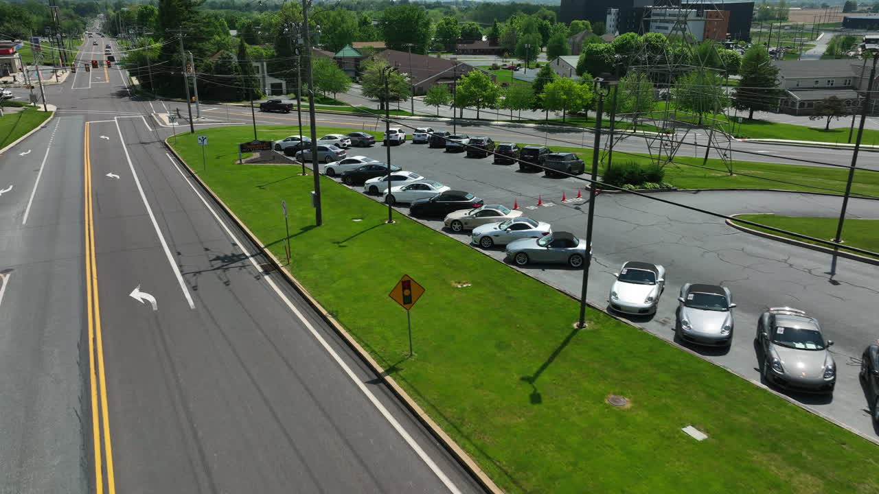 View of sports cars. Parked cars along main street. Colorful, fast, expensive vehicles sit in sunshine on summer day in America.
