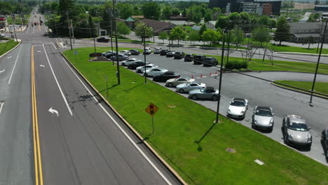 view of sports cars. parked cars along main street. colorful, fast, expensive vehicles sit in sunshine on summer day in america.