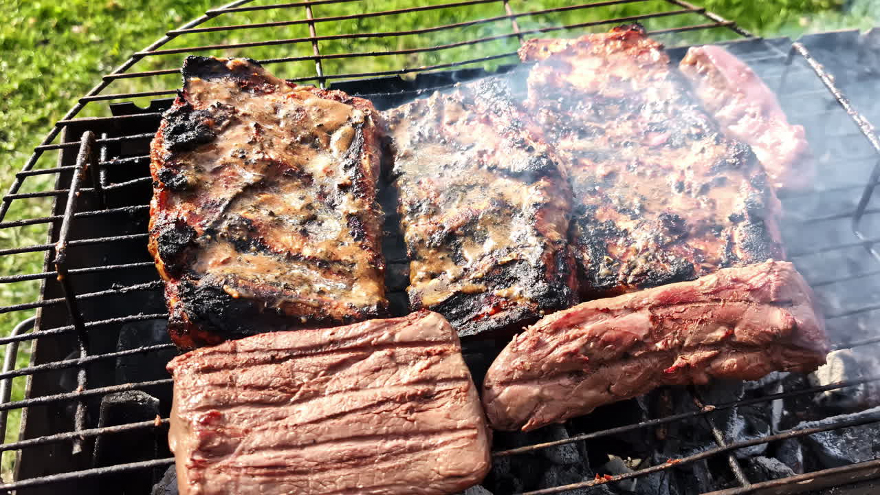 Delicious meat sizzling on the BBQ grill, cooked outdoors under the warm sunshine.