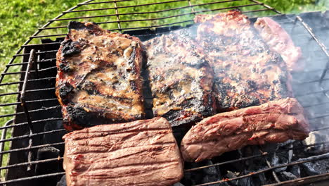 delicious meat sizzling on the bbq grill, cooked outdoors under the warm sunshine.