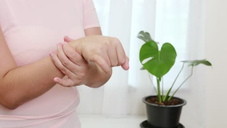 women doing hands stretching and exercising to protect office syndrome and hand arthritis after work at home office day