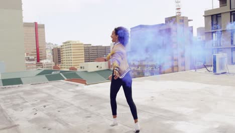 Fashionable-young-woman-on-urban-rooftop-using-a-smoke-grenade