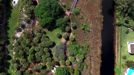 An-aerial-view-of-a-park-with-an-elevated-walkway-over-marsh-water-in-Florida-on-a-sunny-day