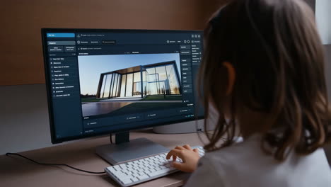 person working on a computer displaying architectural design software