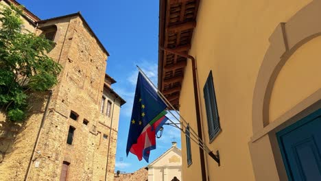 european and italian flags waving in the breeze