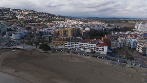 panoramic aerial of beachfront buildings and coastal curve in peniscola under soft light