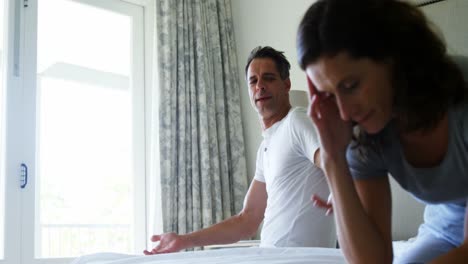 pareja infeliz teniendo una discusión en el dormitorio