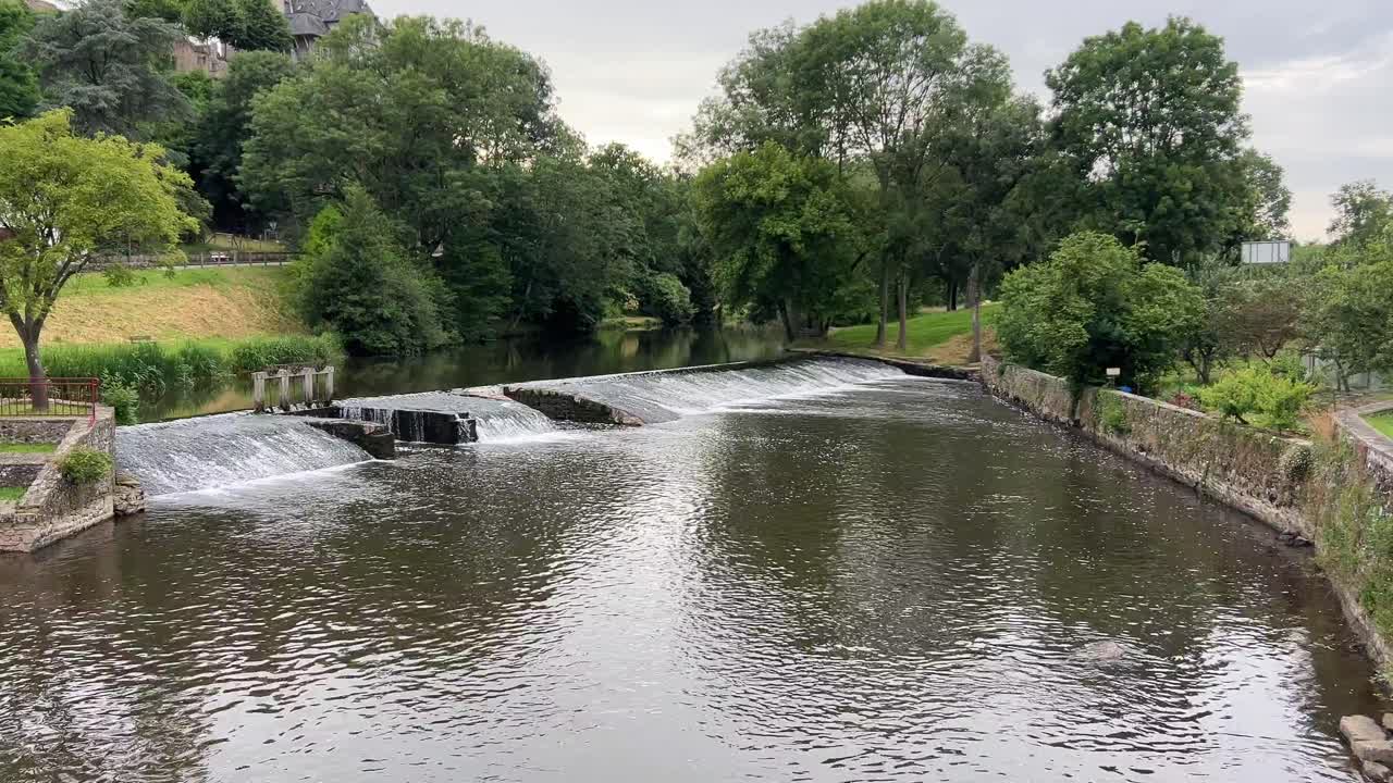 River oxygenating over a man made weir with interesting patterns in the water