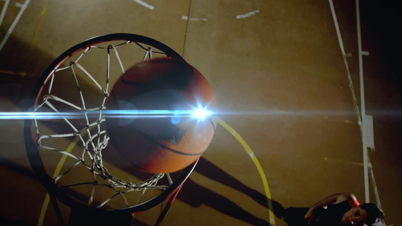 Male player entering from left, jumping beside rim, powering dunk with ball, scoring for sports