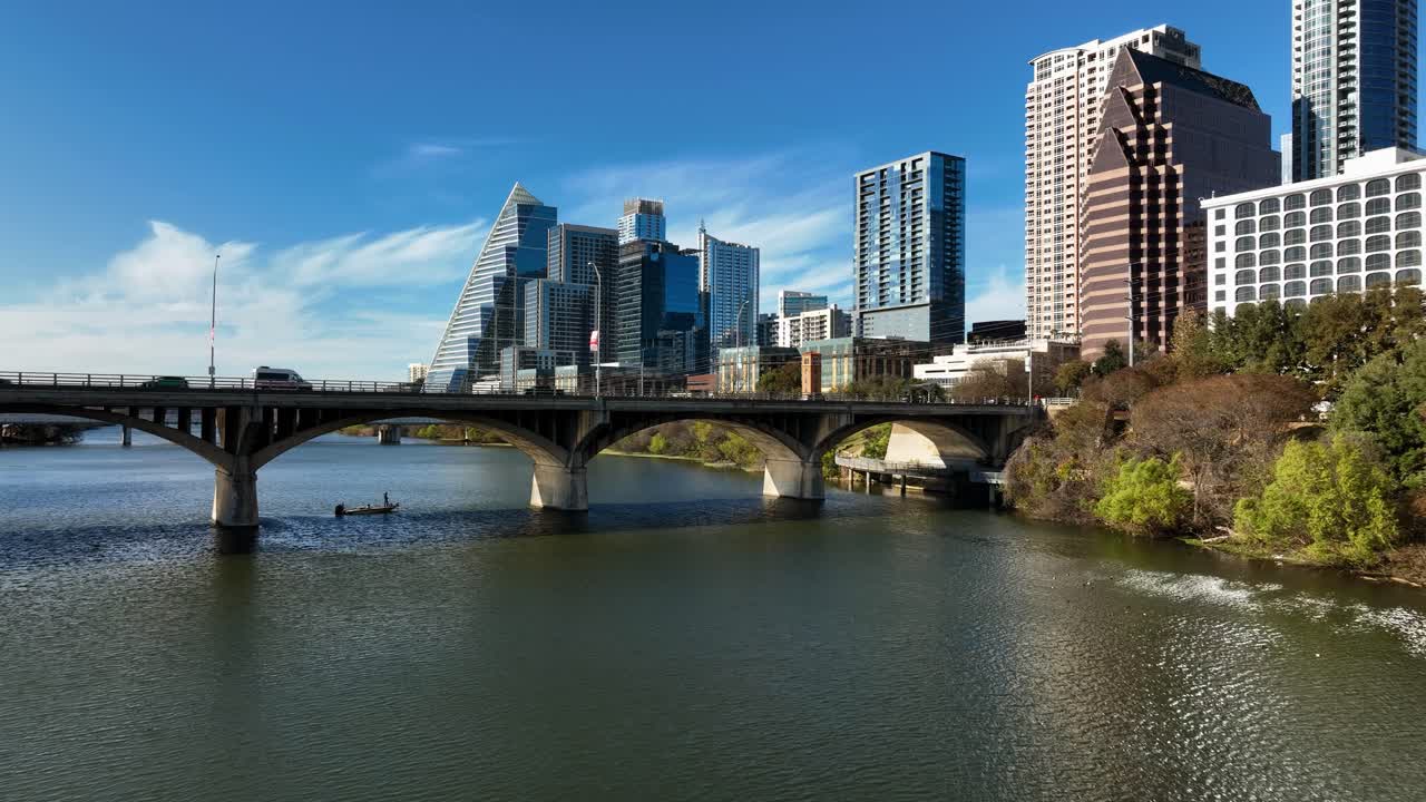 Aerial view low over the Colorado river towards the Congress Avenue Bridge, fall in Austin, Texas, USA