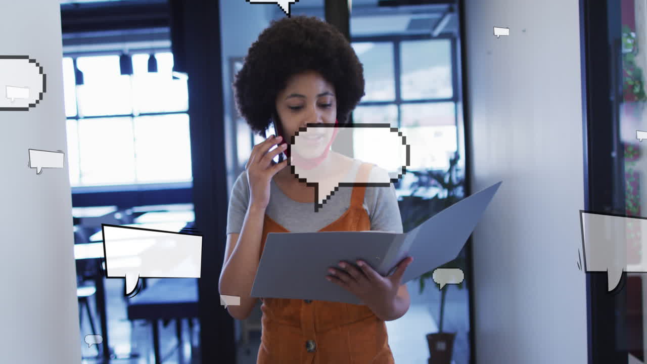 Animation of speech bubbles over african american businesswoman talking on smartphone