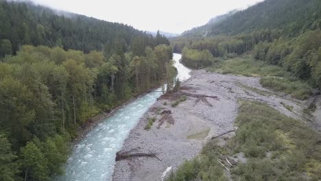 Misty-overcast-aerial-flight-up-Nusatsum-River-near-Bella-Coola,-BC