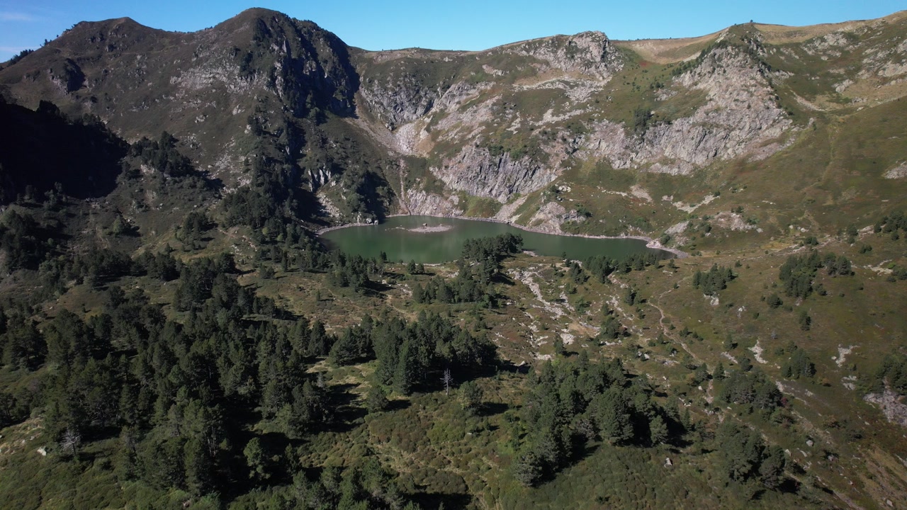 Aerial views of an alpine lake in the french Pyrenees at low altitude