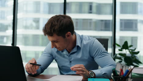 Stressed-man-accountant-worried-company-financial-results-sitting-office-closeup