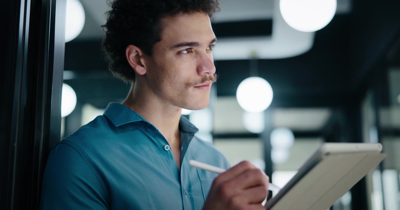 Young Professional Using Digital Tablet in Modern Office