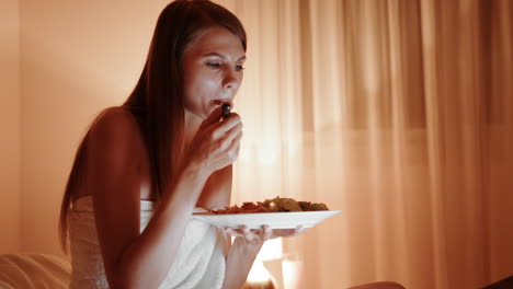 woman eating dinner in bed