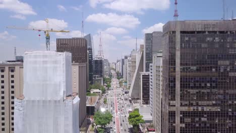 skyscrapers in sao paulo city center street avenida paulista, the economic center of brazil-drone footage tilting shot