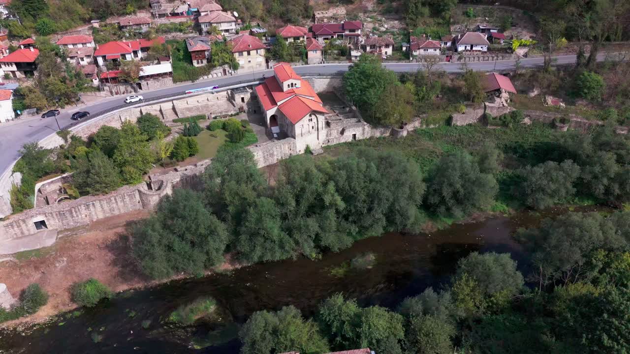 Distant drone pan around Holy Forty Martyrs Church, revealing historic Veliko Tarnovo and landscape below.