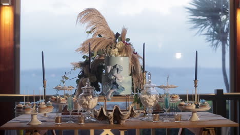 dessert table with blue cake centrepiece