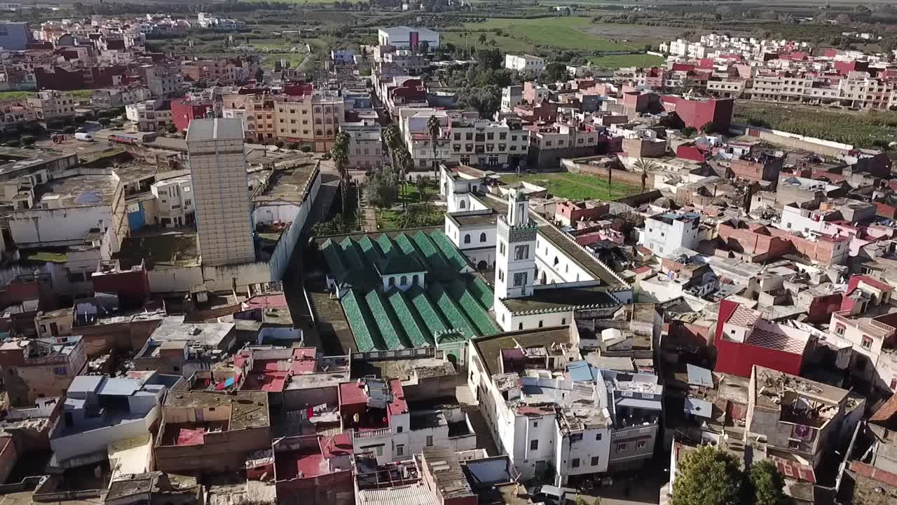 Cảnh quay drone mê hoặc trên trung tâm Larache. Nổi bật là mái ngói xanh biểu tượng của Nhà thờ Hồi giáo Lớn, tháp minaret trắng của nó và kiến trúc đô thị sầm uất, dày đặc của thành phố lịch sử.