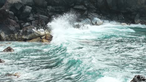 powerful waves splashing over rocky coastline of tenerife, slow motion