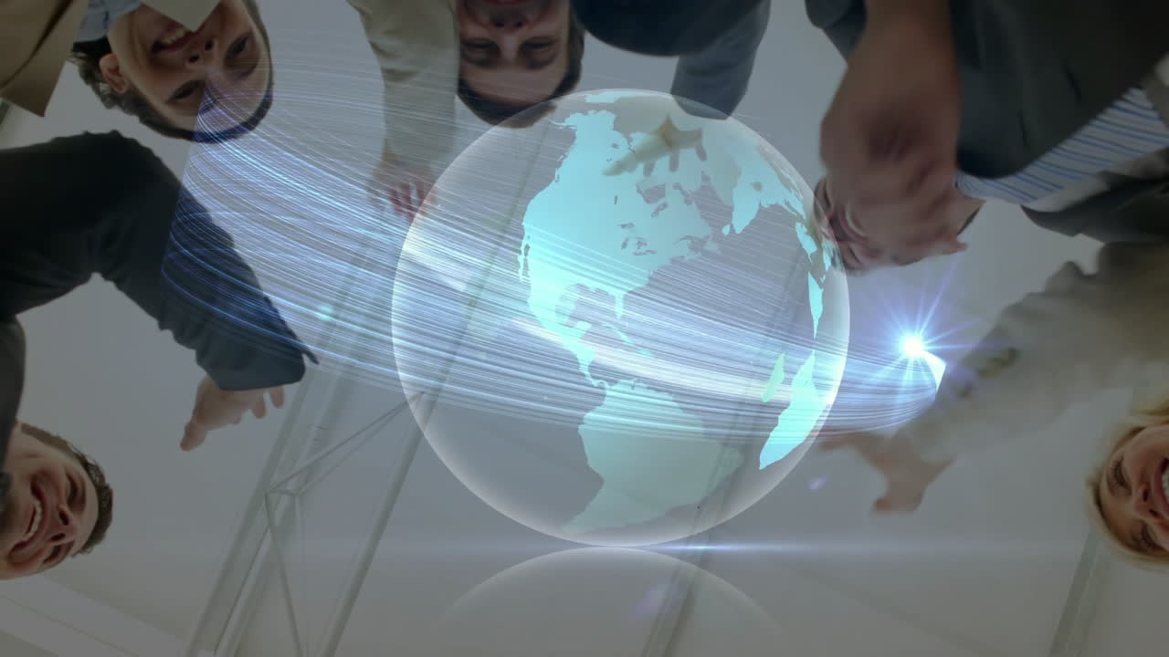 Diverse group of people joining hands with digital globe animation overlay