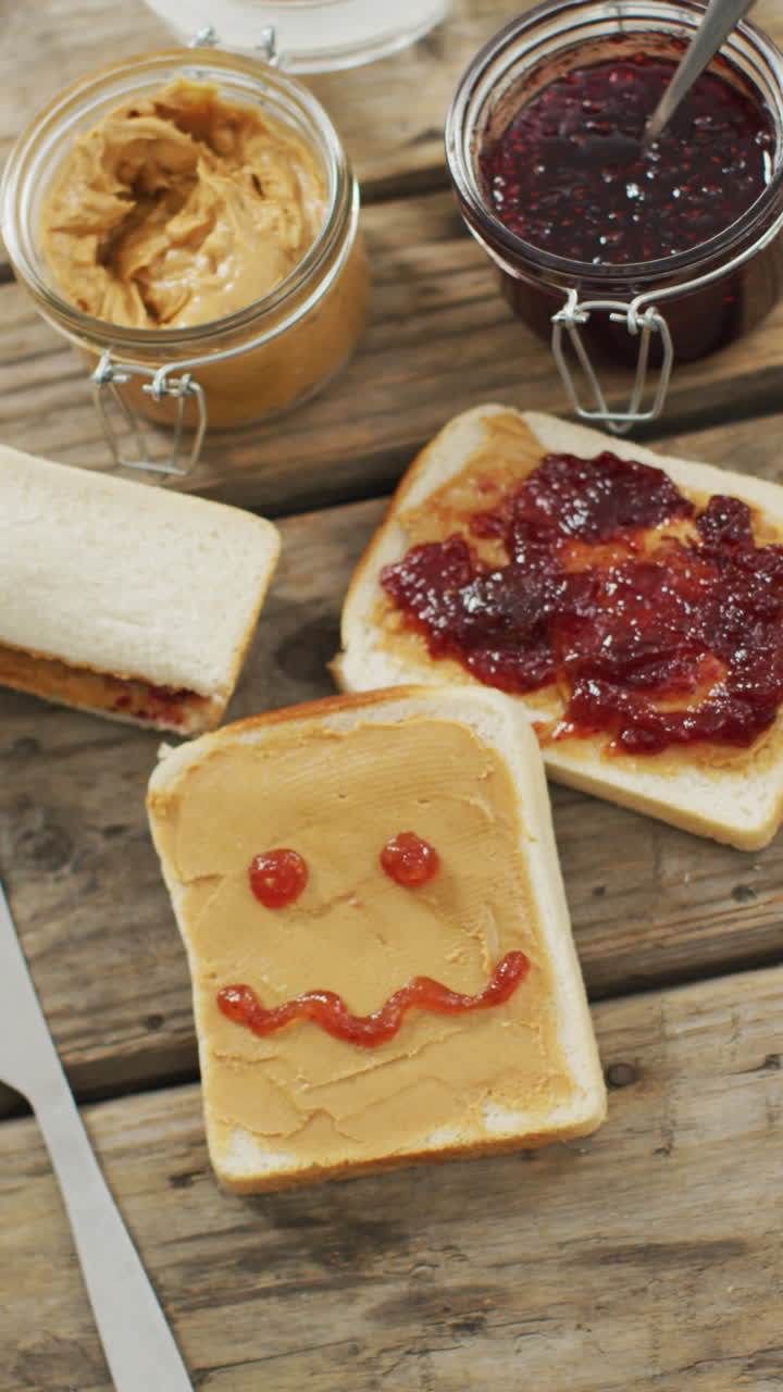 Vertical video of sandwiches with jam and peanut butter