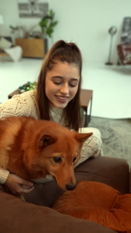 girl and dog having fun at home