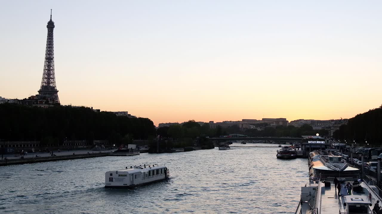 Distant view of the Eiffel Tower in the evening with buildings surrounding it and the Seine in Paris, France