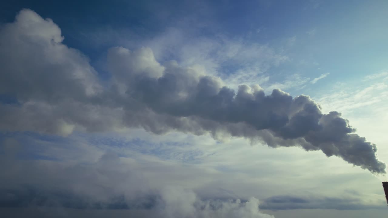 Smoke from Industrial Chimney Against a Cloudy Sky