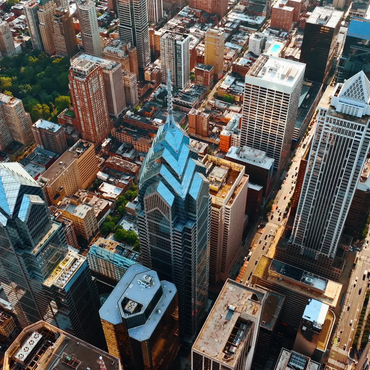 Panorama of sunny Philadelphia at daytime. Drone goes down above the luxurious skyscrapers. Top view