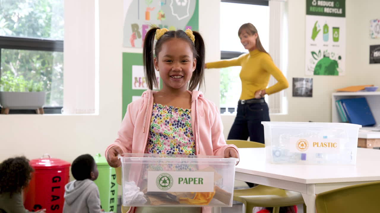 In school, child sorting paper for recycling, smiling and learning sustainability