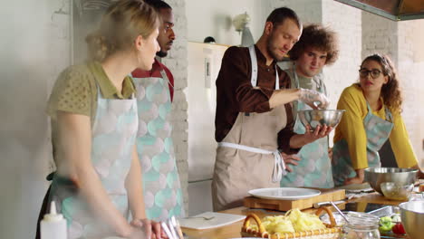 chef teaching students how to make salad during cooking master class