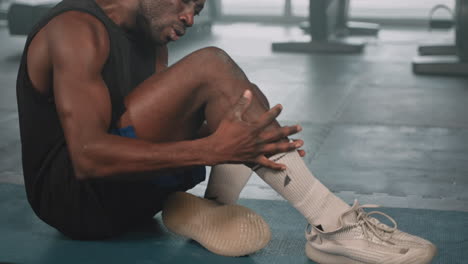 man with a leg injury in a gym