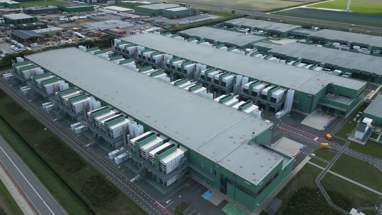 Wide aerial view of an advanced industrial data center park in Eemshaven, used for AI applications, cloud infrastructure, and digital services. The site showcases innovation