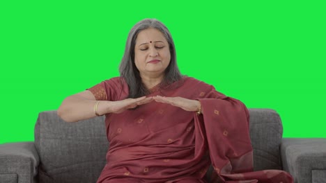 Happy-Indian-old-woman-doing-breathe-in-breathe-out-exercise-Green-screen