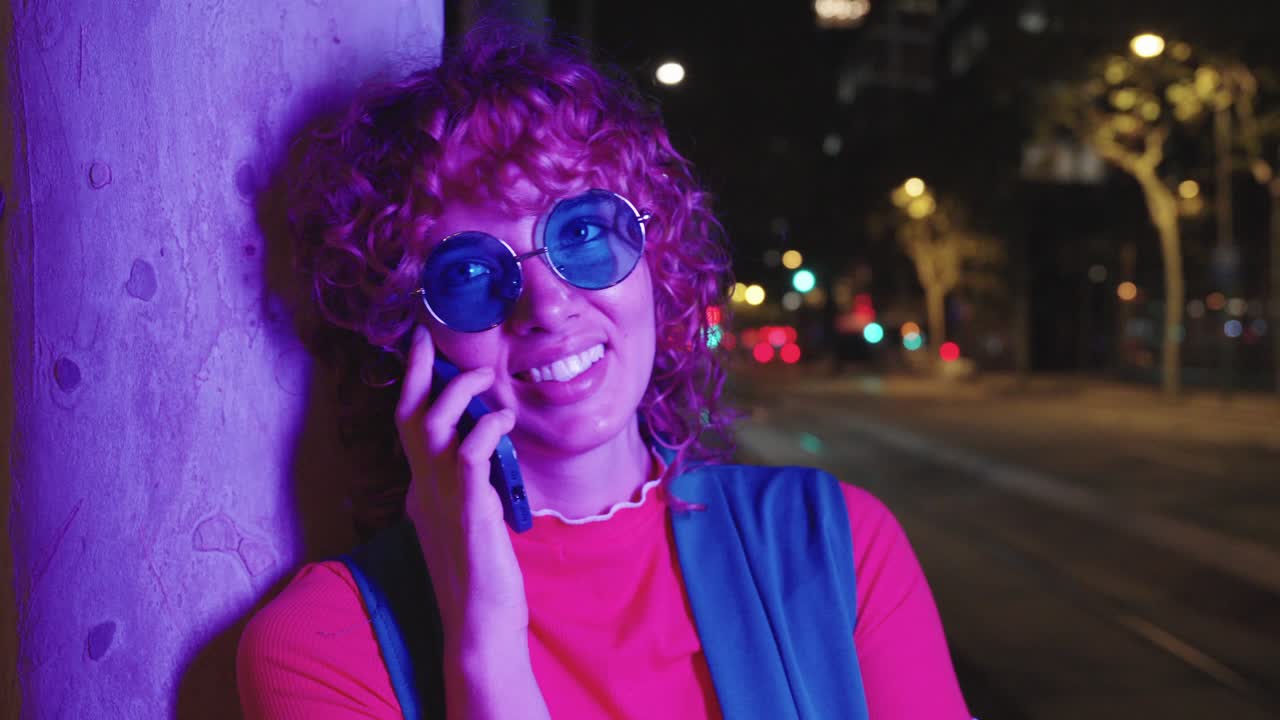 Woman talking on the phone at night in the city