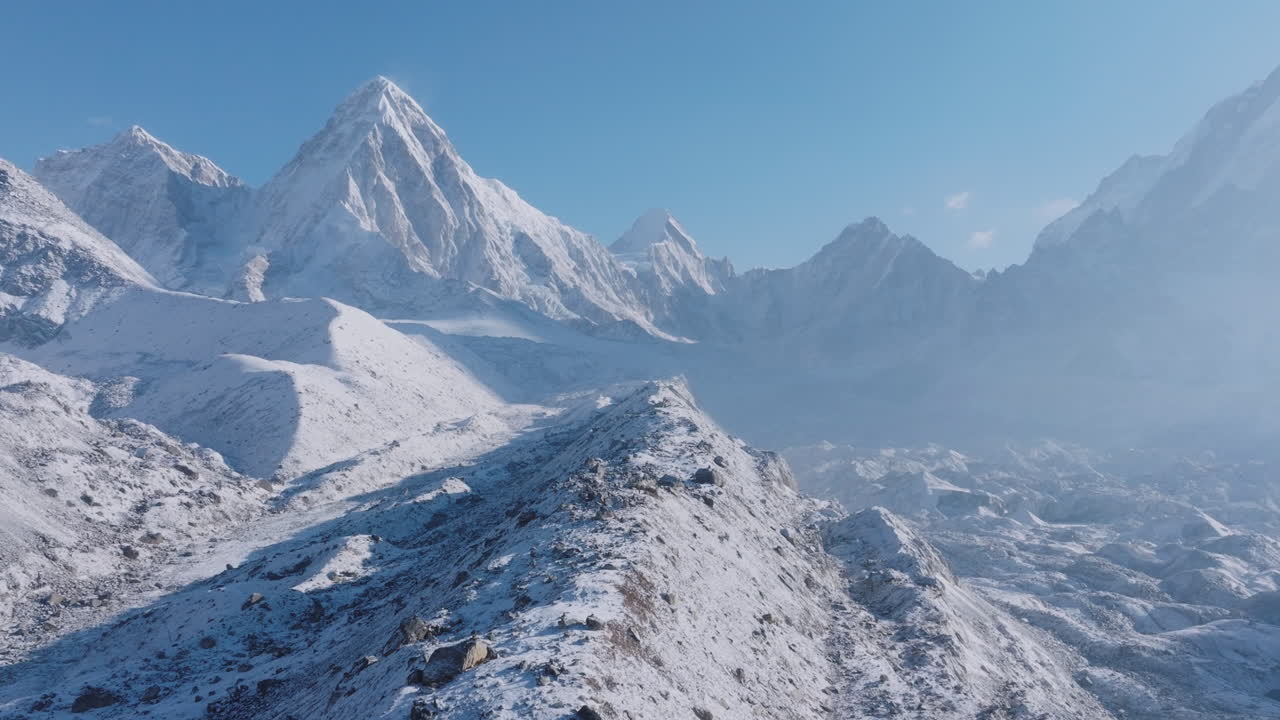 Aerial drone view over Everest Base Camp trek in Khumbu, Nepal. Morning light reflects off snow-capped 8000m Himalayan peaks and Khumbu Glacier, creating a breathtaking tourism and nature landscape