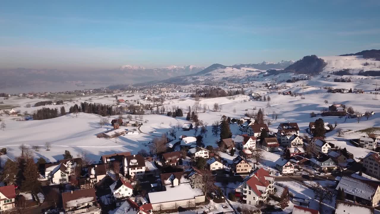 vuelo sobre un pequeño pueblo en suiza durante el invierno