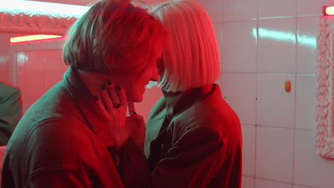 loving couple dancing in red neon light