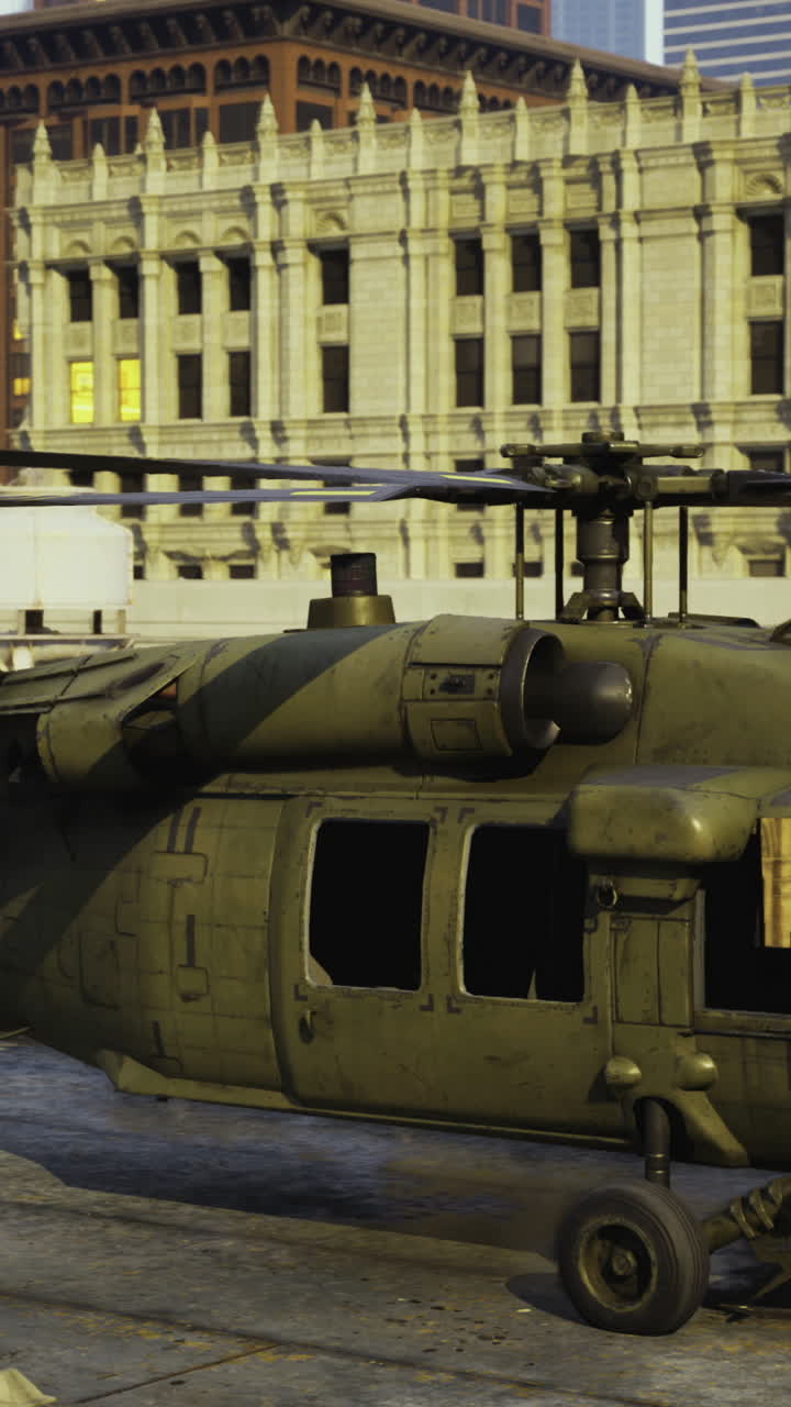 Military helicopter on urban rooftop during sunset with city skyline backdrop