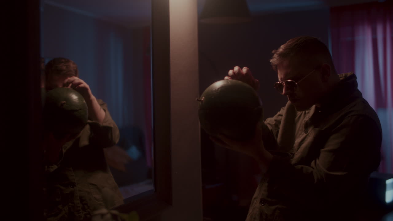 Man Holding Watermelon in Front of Mirror