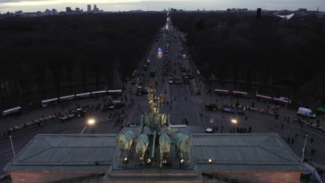 Riding-shot-of-famous-sculpture-on-top-of-Brandenburger-Tor.-Revealing-protesting-farmers-in-city-centre.--Berlin,-Germany