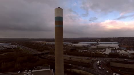 aerial footage of the stoke on trent incinerator recycling centre in the midlands staffordshire, garbage, refuse, waste incineration plant with smoking smokestack creating more industrial pollution