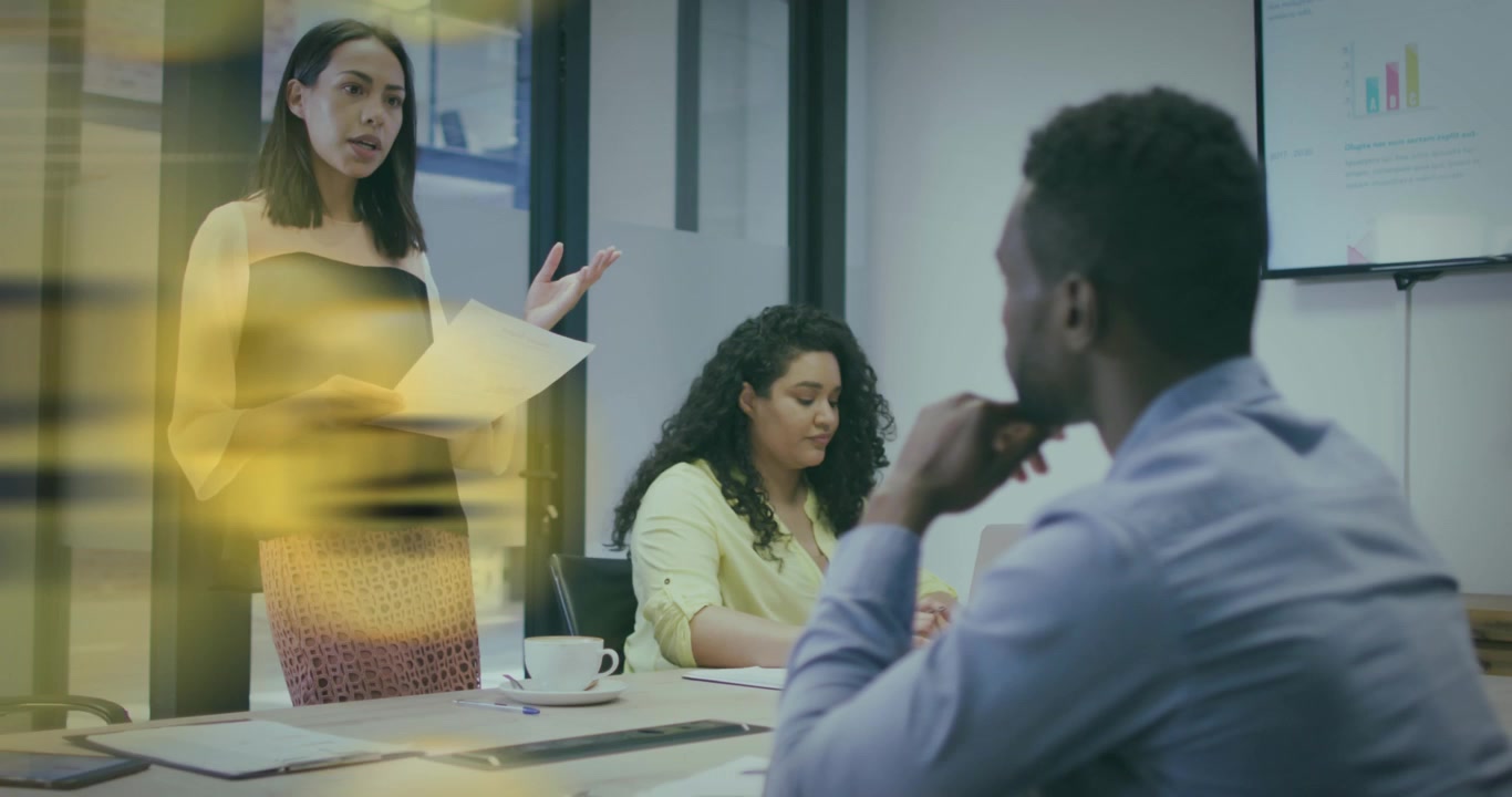 Animation of icons, computer language over diverse coworkers discussing reports in office