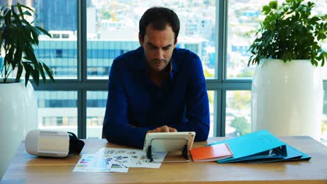 male executive working over digital tablet in office