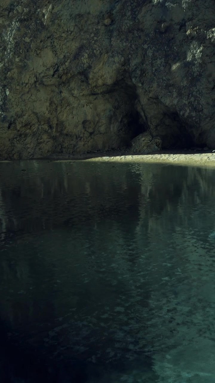 Scenic view of water reflecting rock formations in a cave