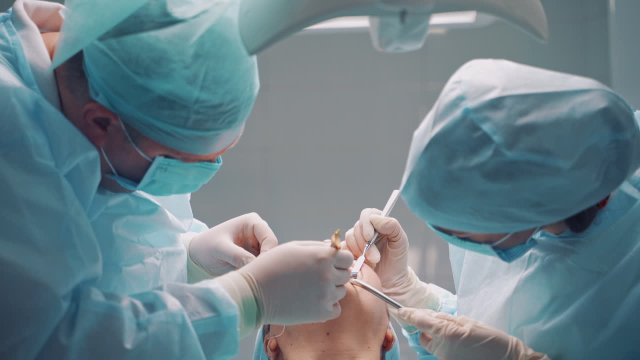 Dental implant surgery. Dentists during surgery for implant placement