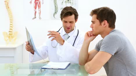 doctor guapo discutiendo rayos x con su paciente